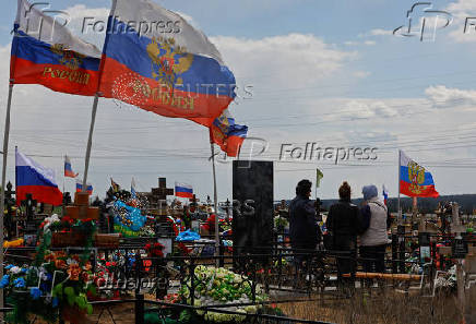 People visit a cemetery in Donetsk