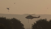 Wildfire burns near a residential neighborhood