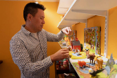 CEO Jason Cheung of toy manufacturer Huntar Company Inc adjusts some of the toys on display at his U.S. office in Union City