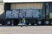 A worker walks near a truck carrying aid at the Kerem Shalom crossing between Israel and Gaza, before going into Gaza, on the Israeli side of the Israel-Gaza border