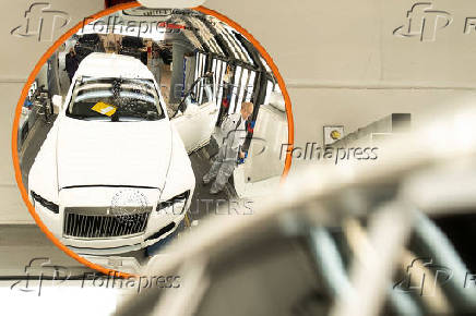 A technician moves the body of a Rolls-Royce Cullinan on the production line of the Rolls-Royce Goodwood factory, near Chichester