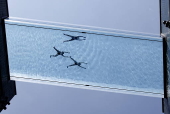 People swim in the Sky Pool during hot weather in London