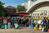 Cambodian people queue to cross the closed Khlong Luek Border Checkpoint