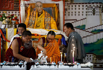 Tibetans mark the 90th birthday celebration of their spiritual leader, the Dalai Lama, at Jawalakhel Handicraft Center in Lalitpur