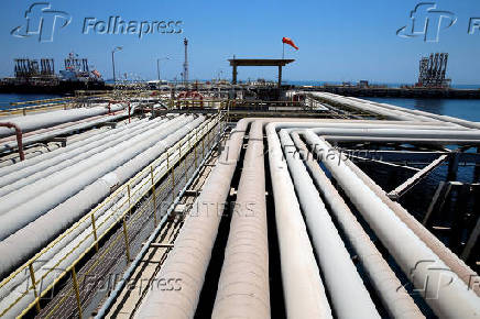 FILE PHOTO: An oil tanker is being loaded at Saudi Aramco's Ras Tanura oil refinery and oil terminal in Saudi Arabia