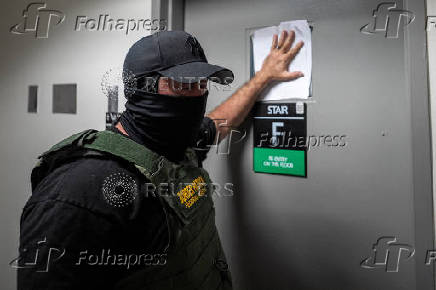 A migrant is detained by federal immigration officers at U.S. immigration court