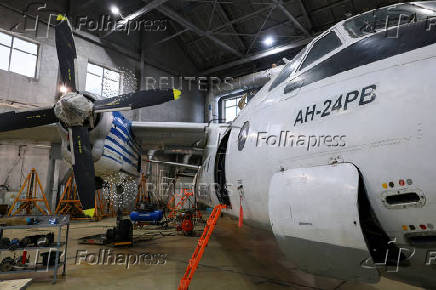 FILE PHOTO: A Polar Airlines' Antonov An-24 passenger aircraft is serviced at an airport in Yakutsk