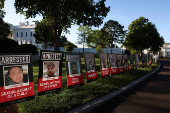 Posters of people described as arrested illegal immigrants are displayed outside the White House in Washington