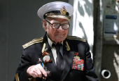 World War Two veteran Nikolai Golubtsov receives congratulations on the upcoming Victory Day in Sevastopol