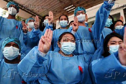 FILE PHOTO: Medical workers wearing red ribbons pose during a protest against the coup that ousted elected leader Aung San Suu Kyi, at Yangon General Hospital, in Yangon