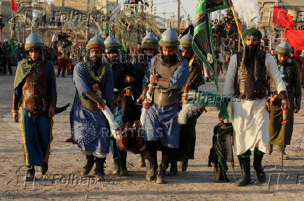 Volunteers re-enact a scene from the 7th-century Battle of Karbala to commemorate Ashura in Baghdad
