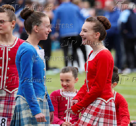 Dancers watch other competitors during the Braemar Royal Highland Gathering at the Princess Royal and Duke of Fife Memorial Park in Braemar, Scotland