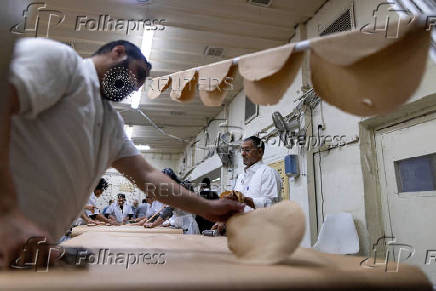 Ultra-Orthodox Jews prepare matza for the upcoming Jewish holiday of Passover