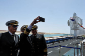 Egypt's Suez Canal Authority removes solid waste from the waters in the passage in Ismalia