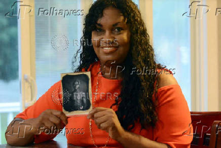 Tamara Lanier holds a copy of an 1850 photo of her enslaved ancestor 