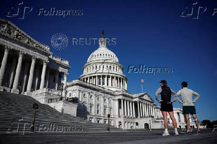 FILE PHOTO: People look the U.S. Capitol on Capitol Hill in Washington