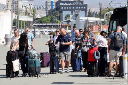 People board Crown Iris, a cruise ship which will be used to assist in the departure of Israelis from Cyprus, at the port in Limassol
