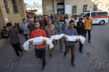 Mourners carry the bodies of Palestinians killed in an Israeli strike, in Gaza City