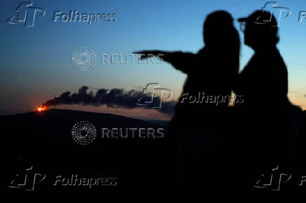 Bonfires burn across Belfast city as part of Loyalist celebrations, in Northern Ireland
