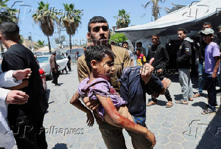 Palestinian casualties are brought into Al-Aqsa Martyrs Hospital, following an Israeli strike, in Deir al-Balah