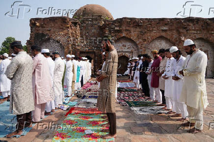 Muslims offer prayers at the ruins of the Feroz Shah Kotla mosque on the occasion of Eid al-Adha, in the old quarters of Delhi