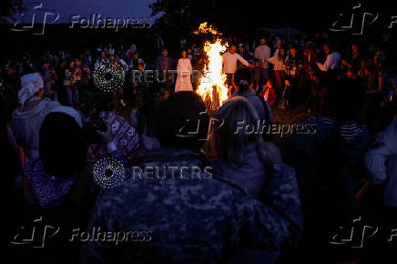 People take part in a celebration on the traditional Ivana Kupala in the village of Vytachiv, in Kyiv region