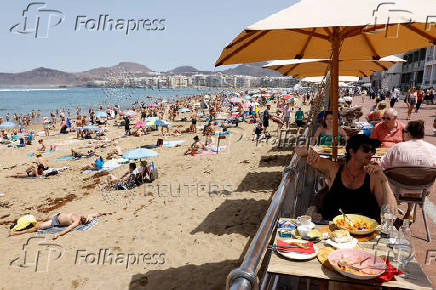 FILE PHOTO: Tourists eat on a terrace next to Las Canteras Beach in Las Palmas de Gran Canaria
