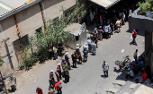 People queue to get bread in Sweida