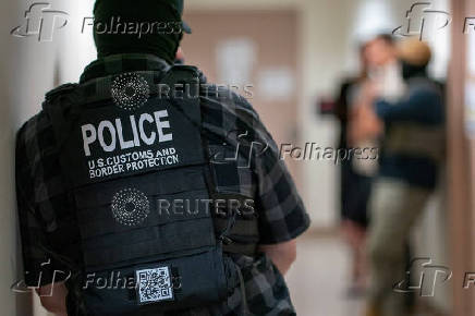 A migrant is detained by federal immigration officers at U.S. immigration court