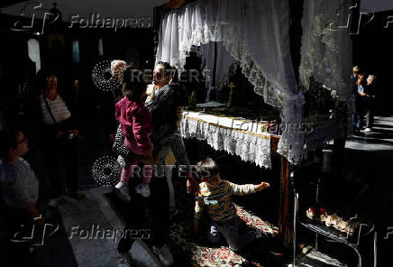 Worshippers gather for the celebrations for the Passion of the Lord at the Church of Saint Clement of Ohrid, on Good Friday, in Skopje