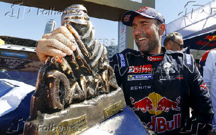 FILE PHOTO: Peugeot driver Peterhansel celebrates with the trophy after he won the Dakar Rally 2016 in Rosario