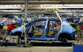 FILE PHOTO: FILE PHOTO: An employee of Nissan Motor works on its Leaf electric car on an assembly line at Oppama plant, in Yokosuka