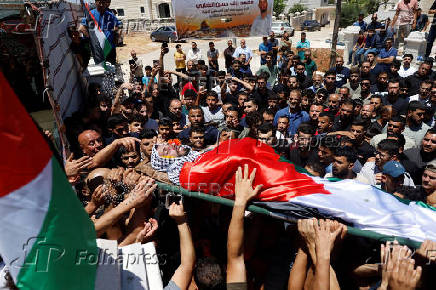 Mourners take part in the funeral of Mohammad Al-Shalabi, near Ramallah