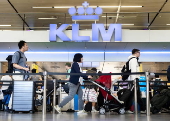 Travelers with their luggage at Schiphol Airport near Amsterdam