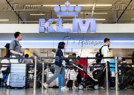 Travelers with their luggage at Schiphol Airport near Amsterdam
