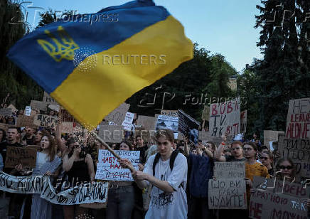 Ukrainians protest against a newly passed law, which curbs independence of anti-corruption institutions in Kyiv