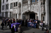 People await a ruling on an appeal by For Women Scotland outside the Supreme Court in London