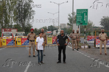 Police officers stand guard next to barricades outside Sri Guru Ram Dass Jee International Airport in Amritsar