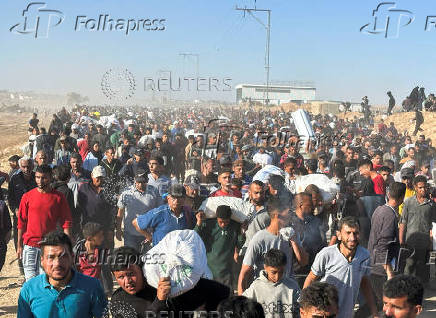 Palestinians receive aid from the U.S.-backed Gaza Humanitarian Foundation, in Khan Younis