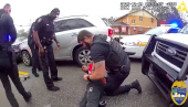 A police officer searches William McNeil Jr at an unidentified location, in Florida