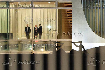 Brazil's Supreme Court Judge Alexandre de Moraes stands next to Brazil's President Luiz Inacio Lula da Silva and Brazil's Prosecutor General Paulo Gonet after a dinner at the Alvorada Palace in Brasilia