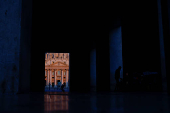 A person walks near St. Peter's Basilica, ahead of the conclave which will be held on May 7, as seen from Rome