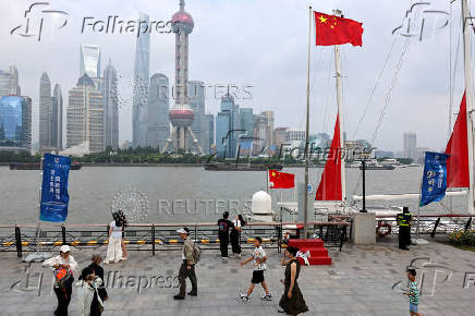 FILE PHOTO: People walk on a promenade in Shanghai