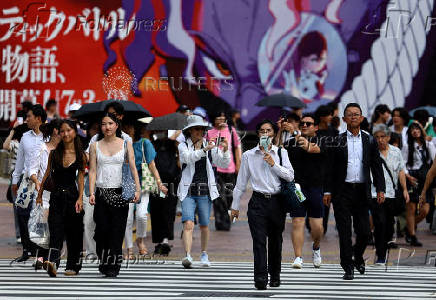 Passersby walk at Shibuya Crossing in Tokyo