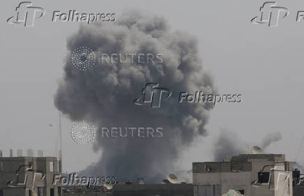 Smoke rises following an Israeli strike, in Khan Younis