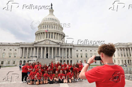 Students take a class photo at the U.S. Capitol in Washington
