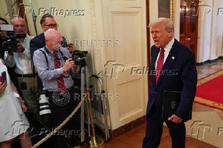 U.S. President Trump signs a resolution at the White House