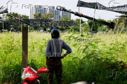 A person watches as military tanks are presented during an annual Han Kuang military exercise, in Tainan