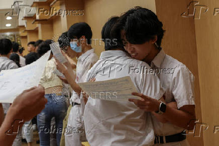 Secondary school students react after receiving their Diploma of Secondary Education (DSE) exam results in Hong Kong
