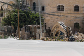 Palestinians carry their belongings after Israel's decision to demolish their homes in Nur Shams camp